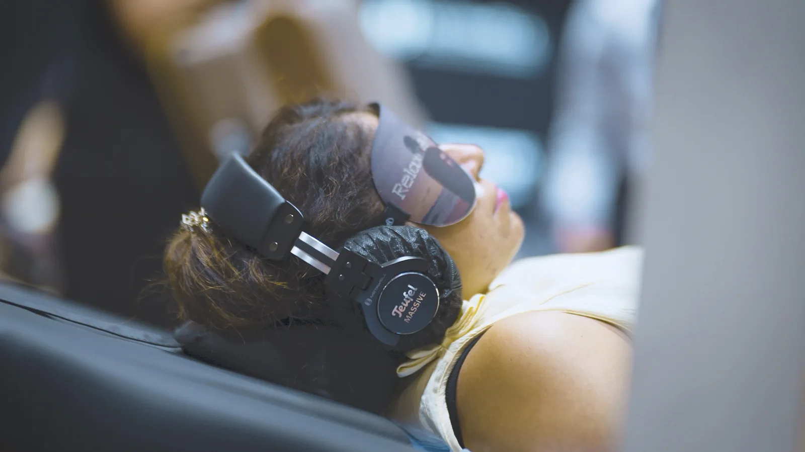 A visitor experiencing a wellness equipment demonstration at an exhibition