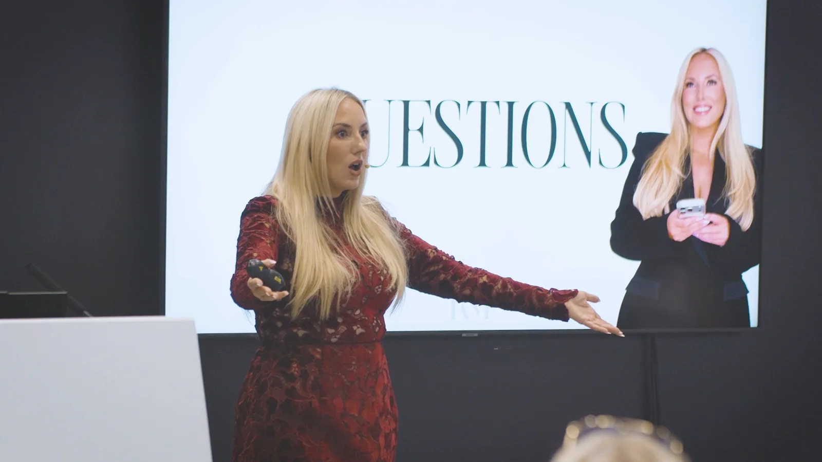 A speaker presenting at a beauty industry event